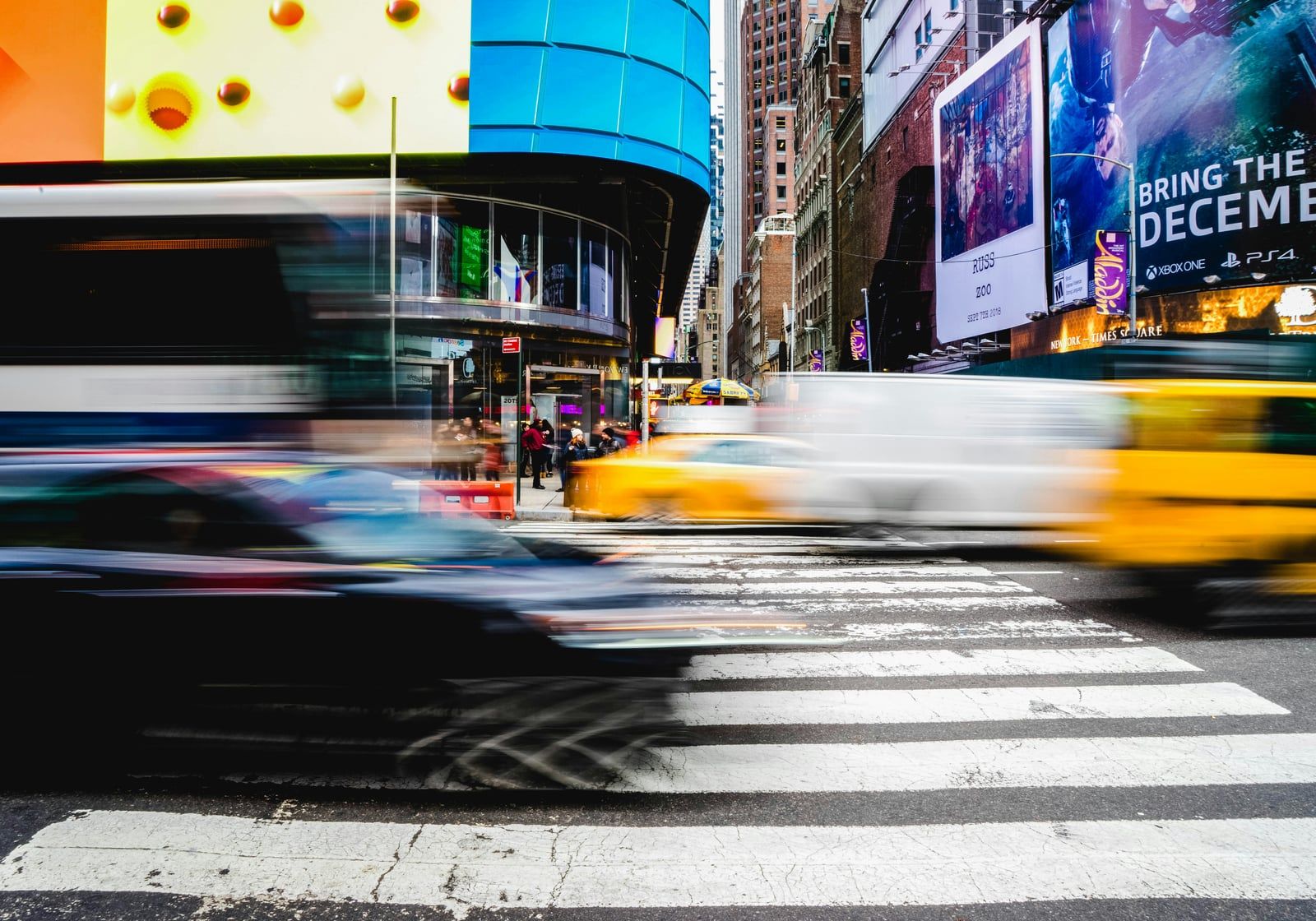 Traffic speeding past billboards in Times Square